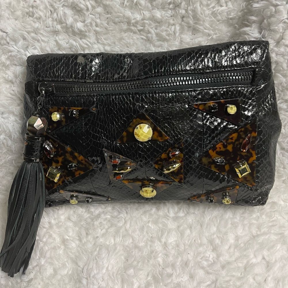 Rafe Black patent snake skin print clutch embellished with jewels and tassel .